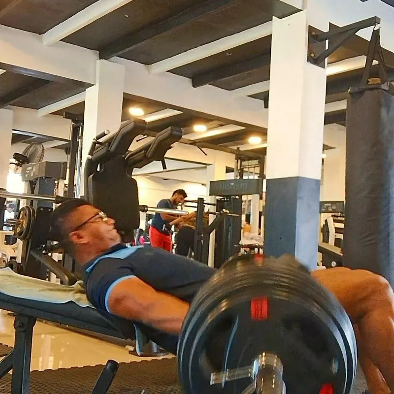 Client performing bench press during a Faith n Muscle training session
