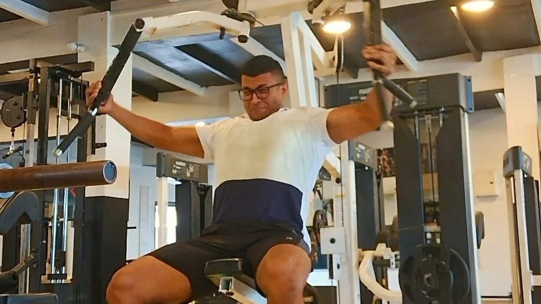 Bernil coaching a client in the gym
